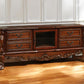 74" Off White Wood And Glass Carved Scrollwork Entertainment Center