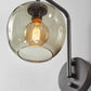 Smoked Glass Globe Shade With Vintage Edison Bulb And Matte Black Metal Wall Lamp