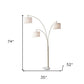 74" Brass Three Light Arc Floor Lamp With Off White Fabric Drum Shade