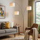 74" Brass Three Light Arc Floor Lamp With Off White Fabric Drum Shade