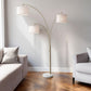 74" Brass Three Light Arc Floor Lamp With Off White Fabric Drum Shade