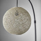 77" Antiqued Bronze Arched Floor Lamp With Groovy Beige Abstract Wicker Globe Shade