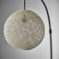77" Antiqued Bronze Arched Floor Lamp With Groovy Beige Abstract Wicker Globe Shade