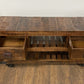 18" Brown and Black Solid Wood Distressed Wheel Console Table With Shelves And Drawers