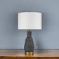 26" Distressed Black and Gold Ceramic Table Lamp With White Drum Shade