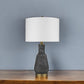 26" Distressed Black and Gold Ceramic Table Lamp With White Drum Shade