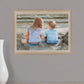 Boy and Girl Sitting in Dunes Brown Framed Print Wall Art