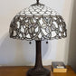 23" Dark Brown Metal Two Light Candlestick Table Lamp With White Shade