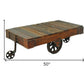 50" Brown and Black Solid Wood and Iron Distressed Wheel Coffee Table