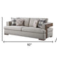 92" Beige Fabric Sofa And Toss Pillows With Brown Legs