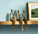 Set of Three Gold Resin People Tabletop Sculpture
