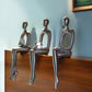 Set of Three Silver Resin People Tabletop Sculpture
