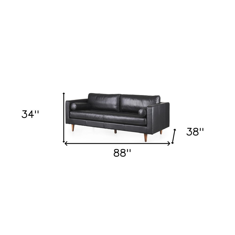 88" Black Leather Sofa And Toss Pillows With Brown Legs