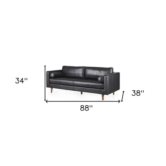88" Black Leather Sofa And Toss Pillows With Brown Legs