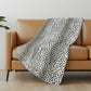 50" X 70" Pearl And Black Animal Print Polyester Woven Plush Throw Blanket
