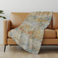 50" X 70" Beige Blue And Gold Abstract Polyester Woven Plush Throw Blanket